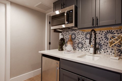 a kitchen with a sink and a microwave
