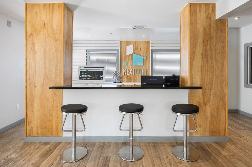 a bar with three stools in front of it at Nextloft Apartments, Bluffton, SC 29910