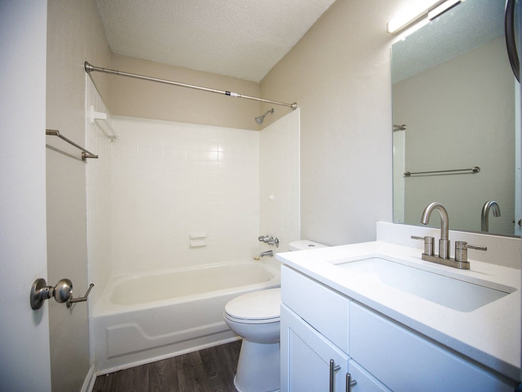 a bathroom with a sink toilet and a tub