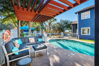 Swimming pool and pergola with seating at NEXTLoft Bluffton, SC apartment rental building - Photo Gallery 3