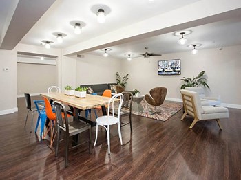 Apartment common area lounge with TV and seating at Arcadia Gardens - Photo Gallery 6