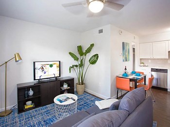 Apartment rental living room with hardwood floors with a view of kitchen at Arcadia Gardens in Phoenix AZ - Photo Gallery 5
