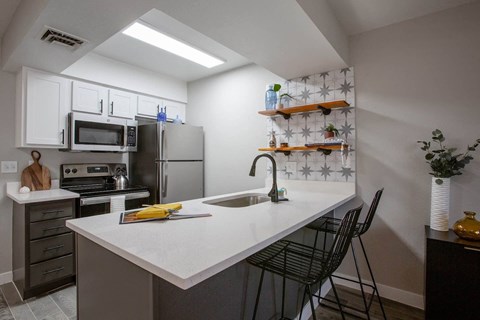 a kitchen with stainless steel appliances and a white counter top