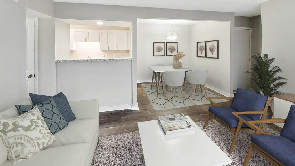 a living room with a couch a table and chairs and a kitchen in the background at Planters Trace, Charleston South Carolina