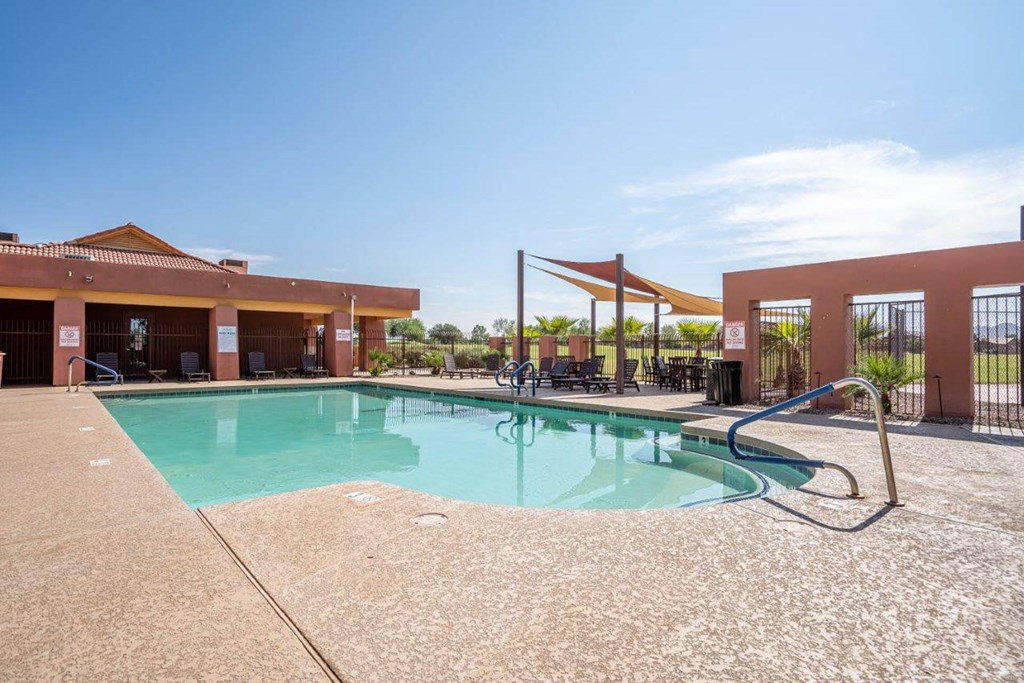 The pool is surrounded by a sundeck with lounge chairs at Village Greens of Queen Creek The pool is surrounded by a sundeck with lounge chairs at Village Greens of Queen Creek