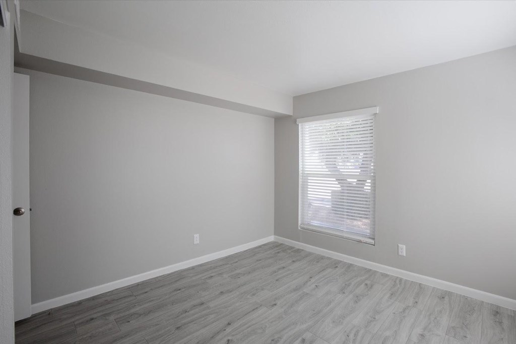 a bedroom with gray walls and a window with a blind at Ascent on Peoria Apartments, Phoenix, AZ 85029