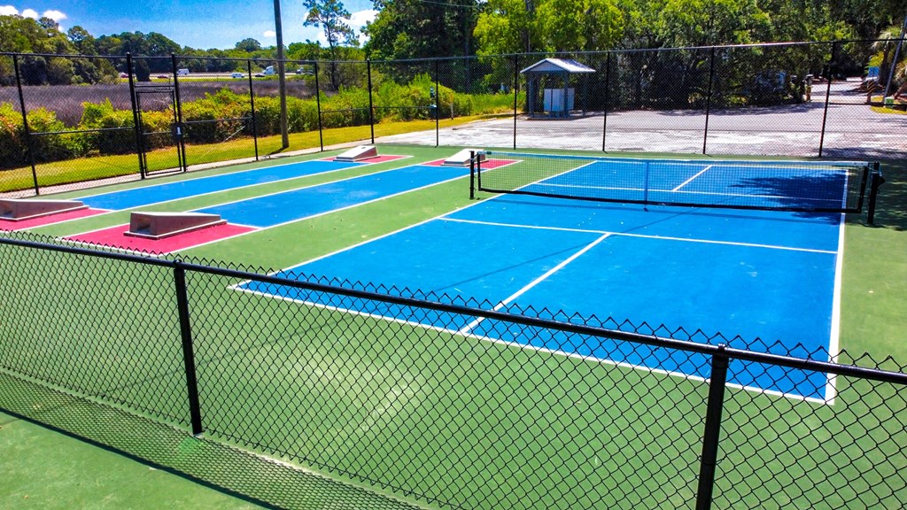a group of tennis courts on top of a fence