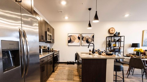 a kitchen with stainless steel appliances and a counter top