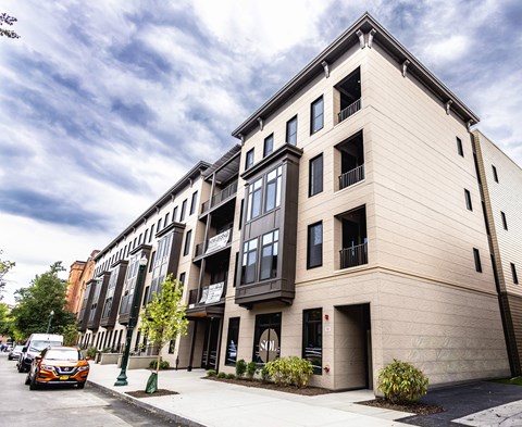 A modern building with a balcony on the second floor.