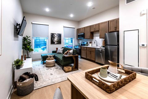 A modern kitchen with a dining table and chairs in the foreground.