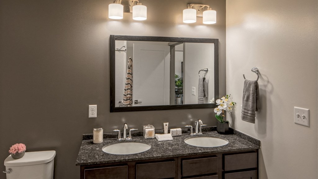 Double vanity with granite countertops in Vicina model bathroom.