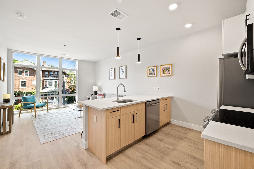 an open kitchen and living room with a sliding glass door to a patio