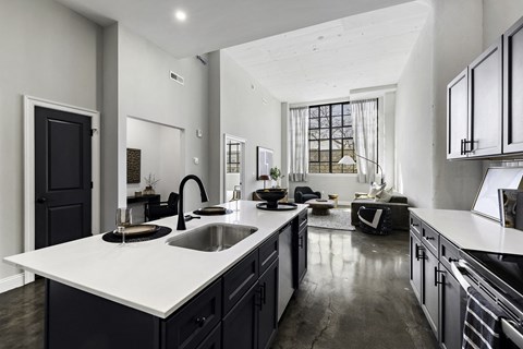 a kitchen with a large white counter top and a sink