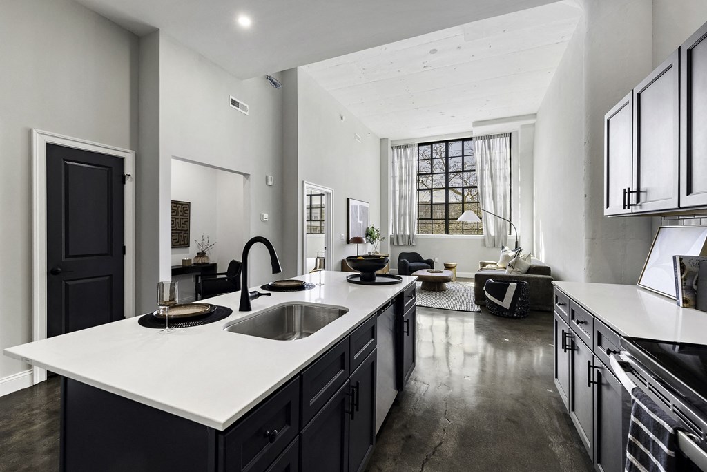 a kitchen with a large white counter top and a sink