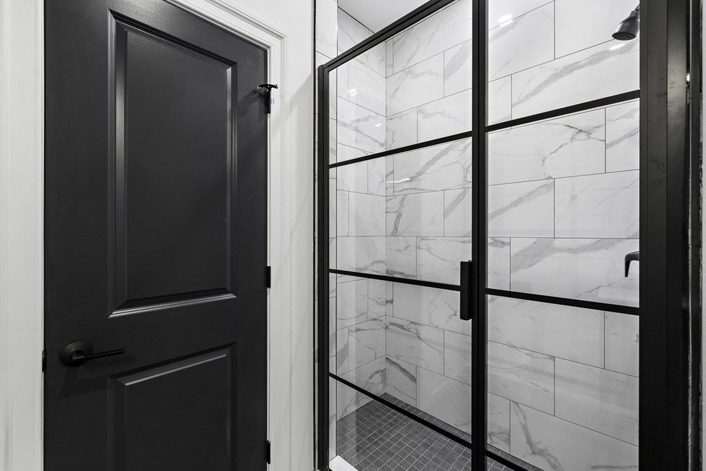 a black and white photo of a glass door with a reflection of a window