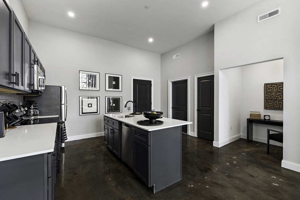 a kitchen with a center island and a counter top in a new home