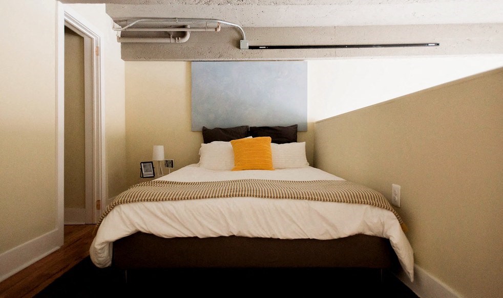 a bed in a small room with a white