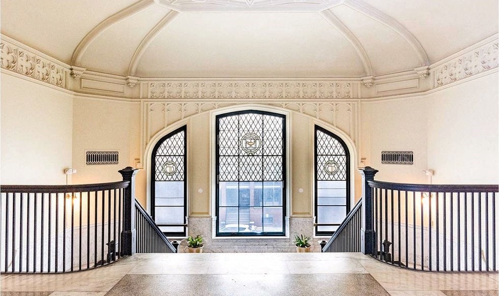a large window in the middle of a staircase in a building