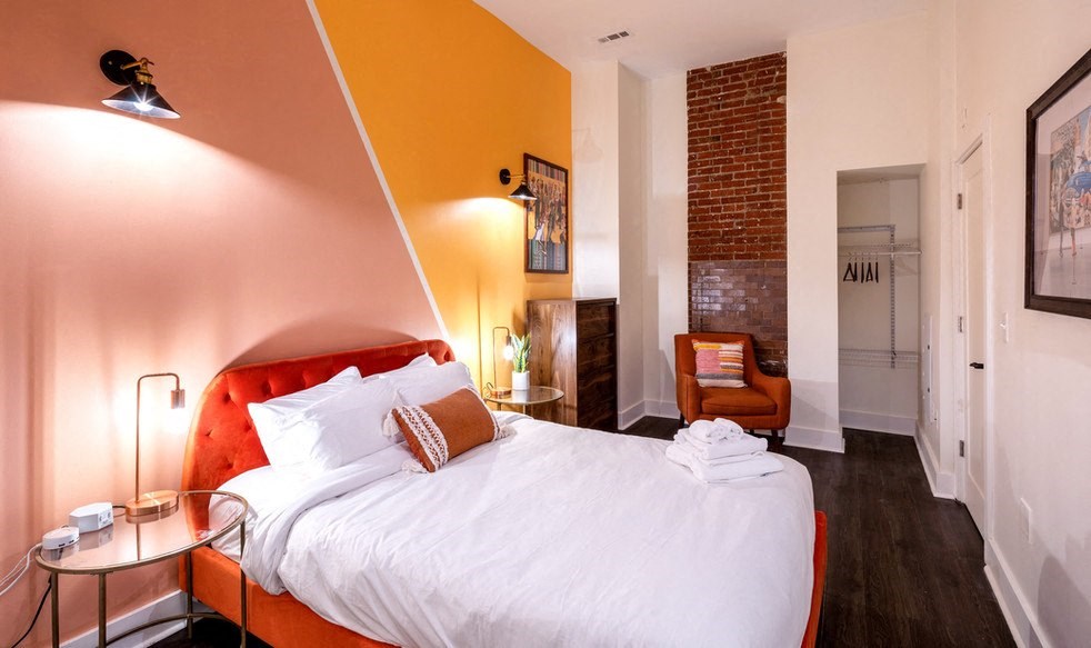 a bedroom with a bed and a chair and a desk