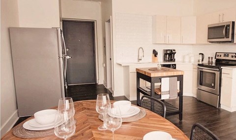 a kitchen and dining room with a wooden table