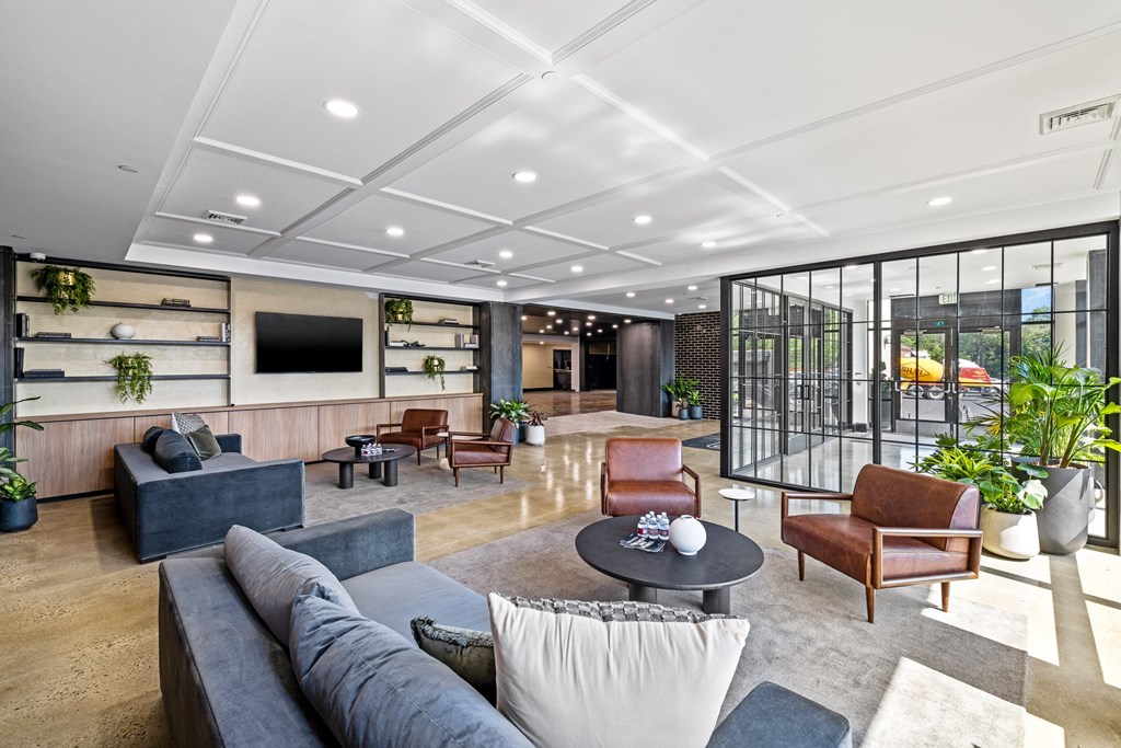 a living room with couches and chairs and a television