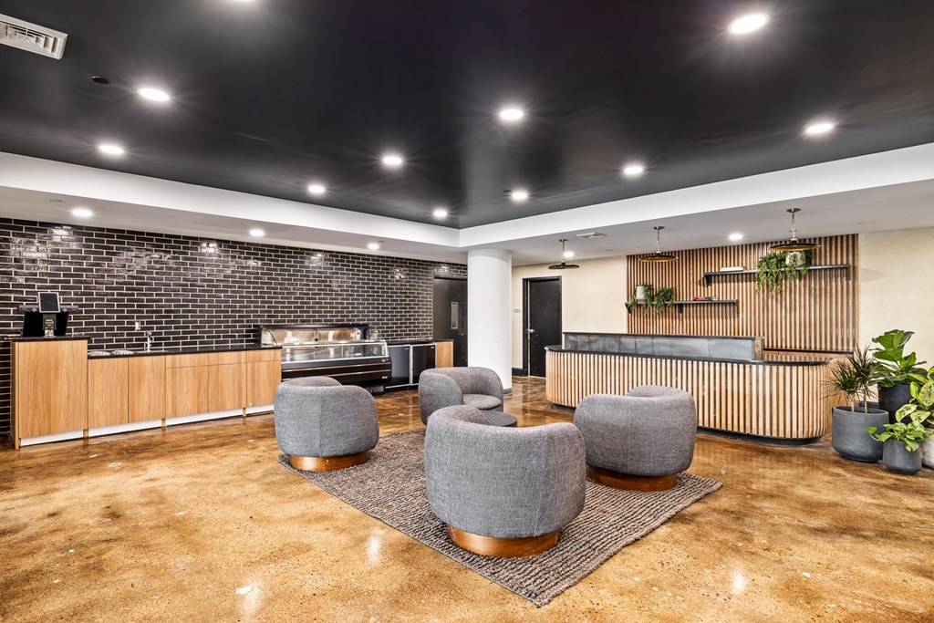a lobby with a reception desk and chairs