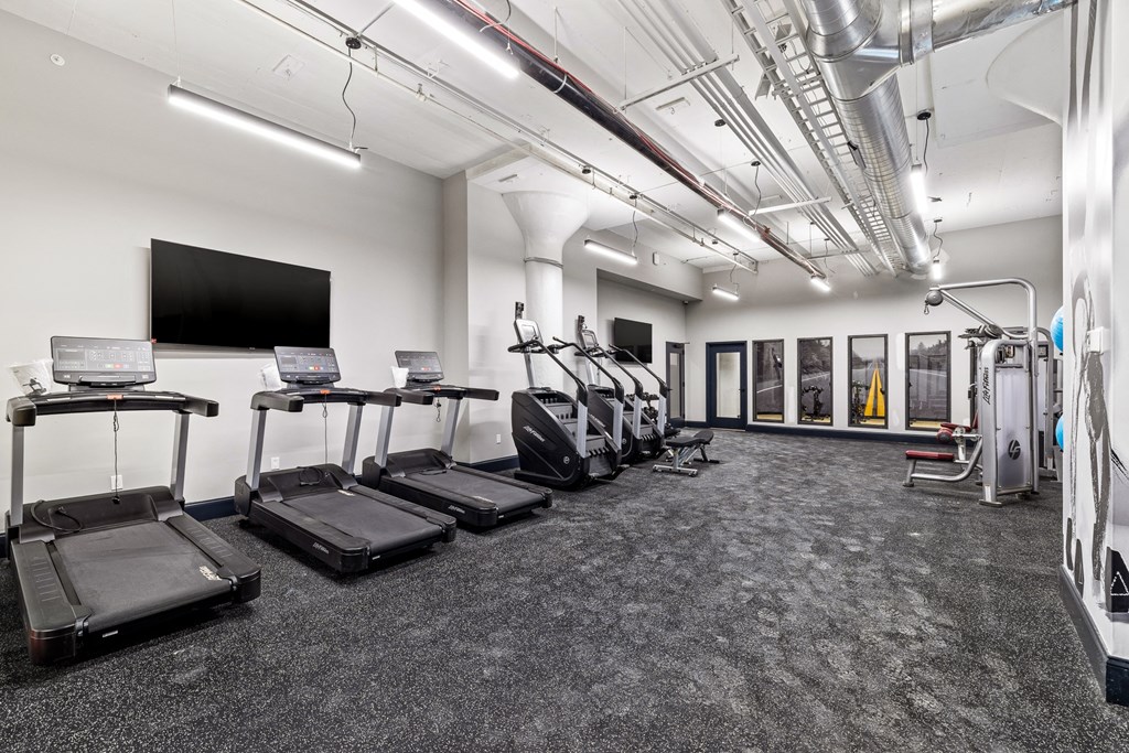 a gym with treadmills and cardio equipment in a building