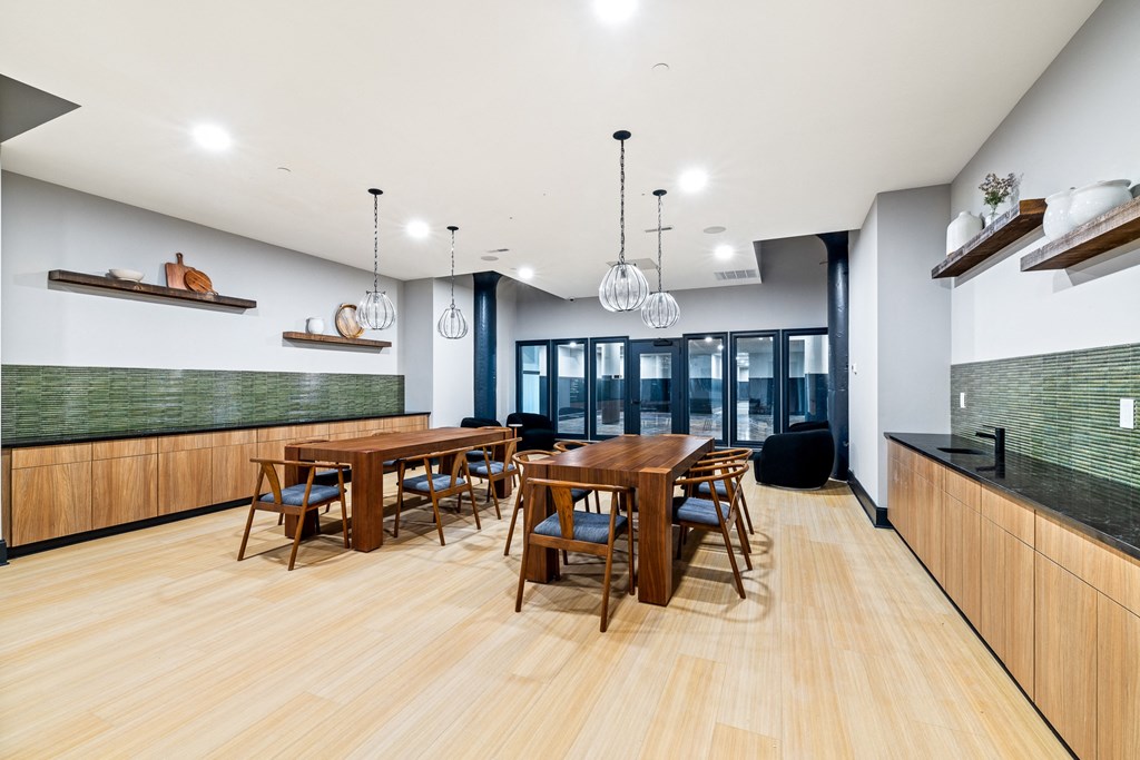 a dining room with wooden tables and chairs and a large window