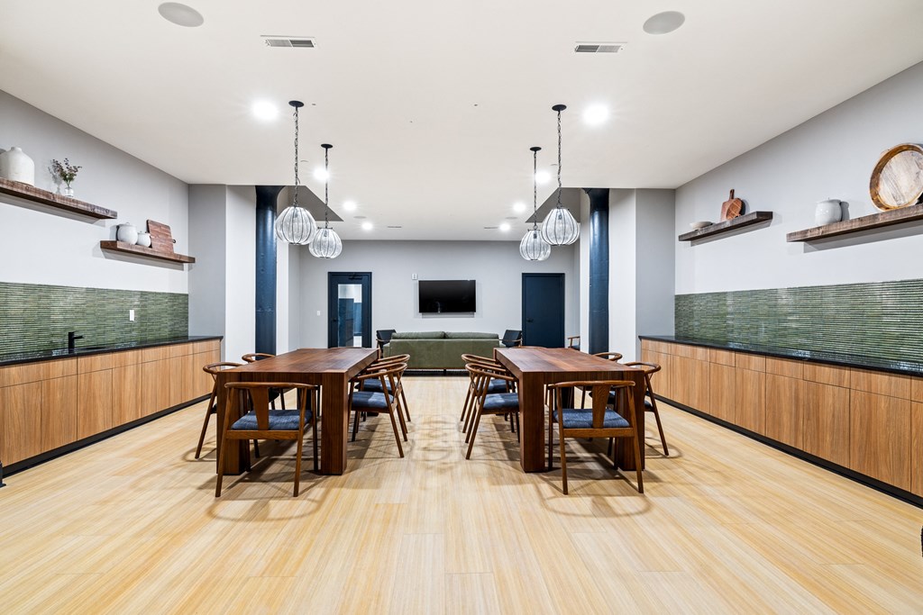 a dining room with wooden tables and chairs and a green couch