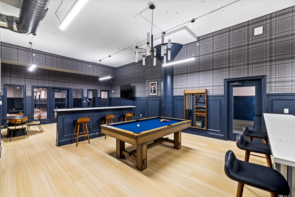 a game room with a pool table and a bar