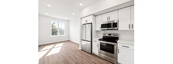 A kitchen with white cabinets and stainless steel appliances.