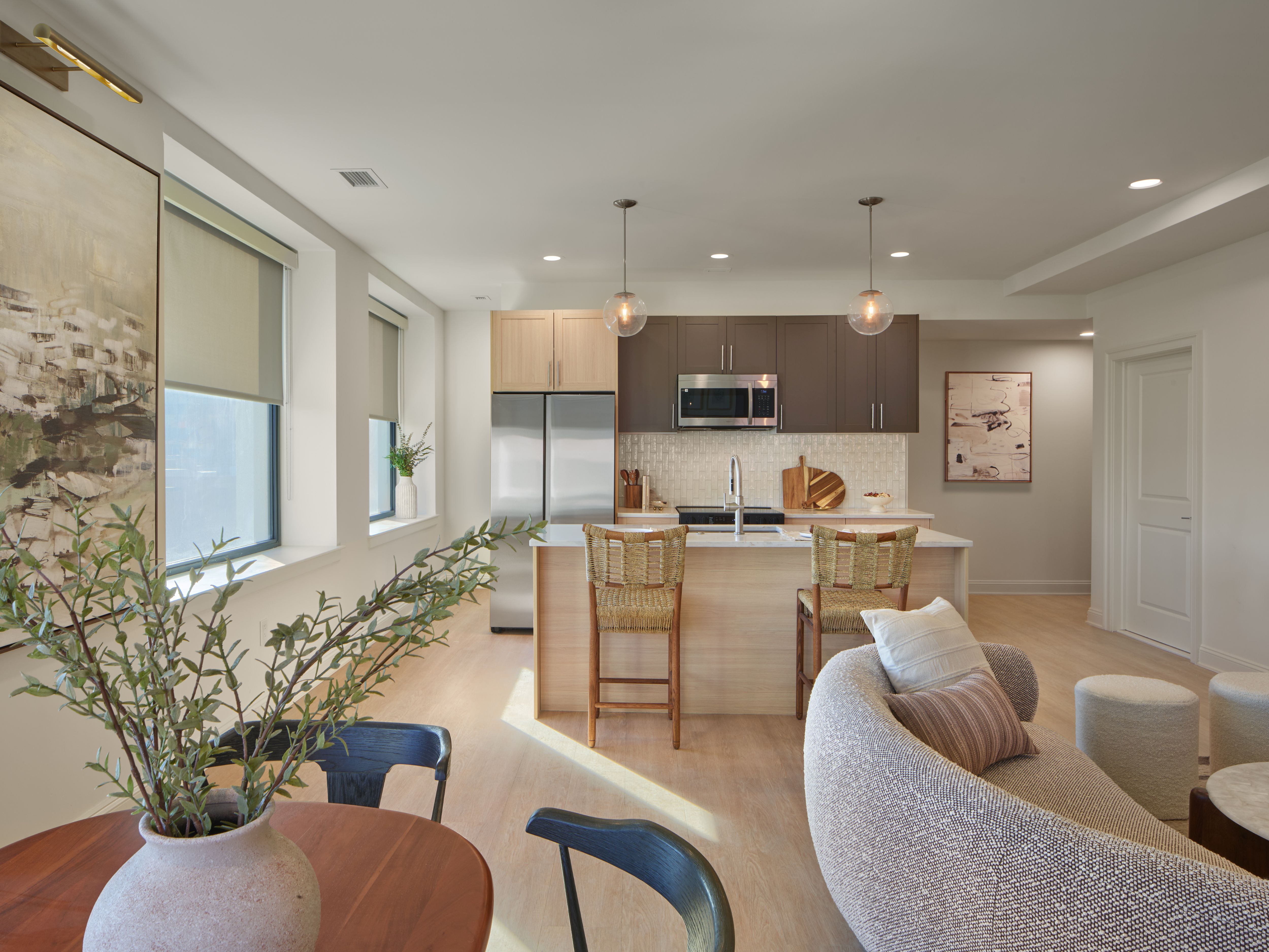 A modern kitchen with a dining table and chairs.