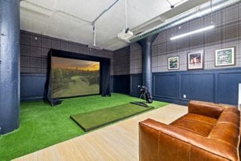 a large room with a couch and a screen in it