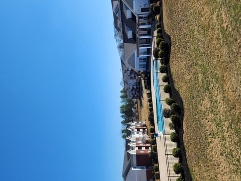 A residential area with houses and a pool.