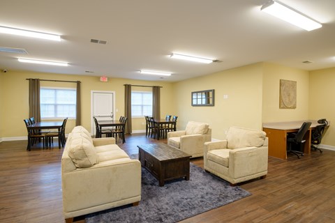 A living room with a white couch and a brown coffee table.