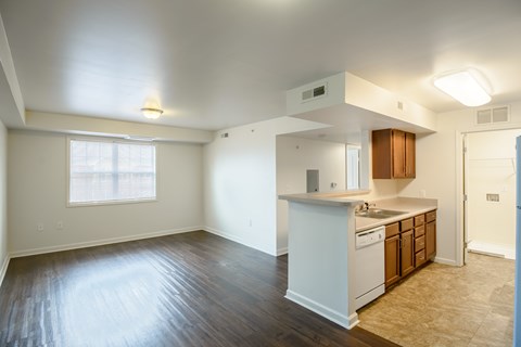 A kitchen with white appliances and wooden cabinets.