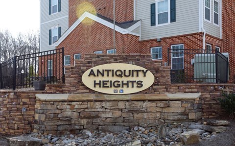 a sign on a brick wall in front of a building