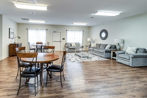 A living room with a wooden table and chairs.