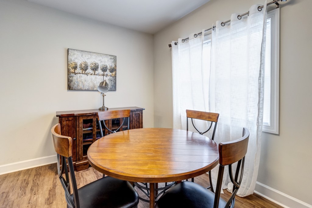 A dining room with a wooden table and chairs. at Ada Park Apartments, Newport News, VA, 23601