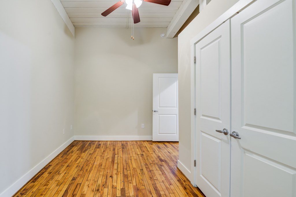Bedroom with a wooden floor.