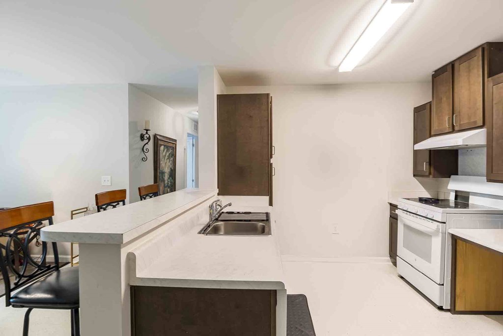 A kitchen with a white countertop and a sink. at Bickerstaff Crossing Apartments, Henrico, VA, 23231