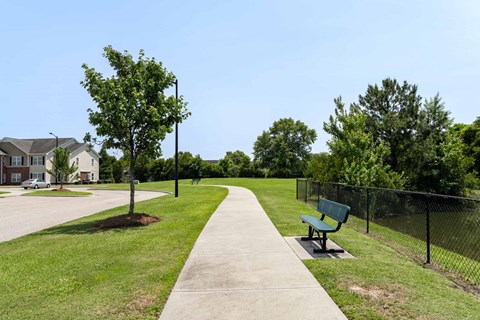 A park with a bench and a fence at Carriage Hills, Lumberton