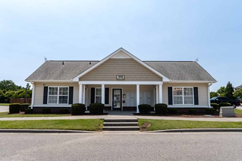 A small white house with a black front door and two windows at Carriage Hills, 28358