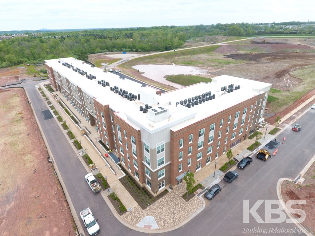 an aerial view of a building and parking lot