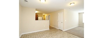 A room with a tile floor and a door on the right side at Granite Falls Apartments, Rolesville, North Carolina