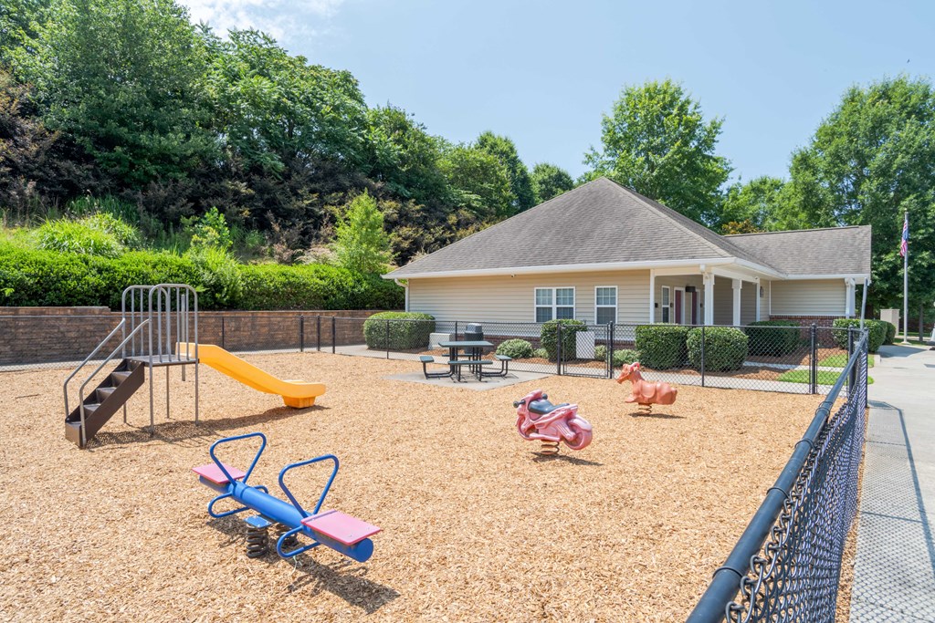 A playground with a slide and seesaws.