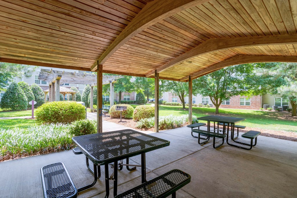 A wooden patio with a table and chairs.