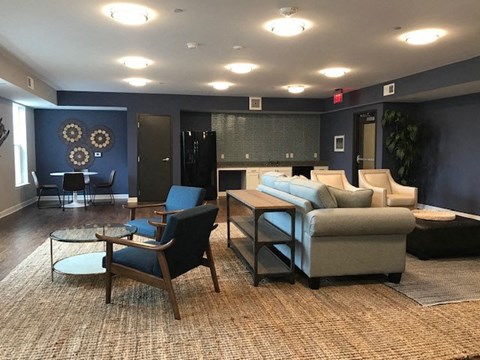 a living room with blue walls and a couch and chairs