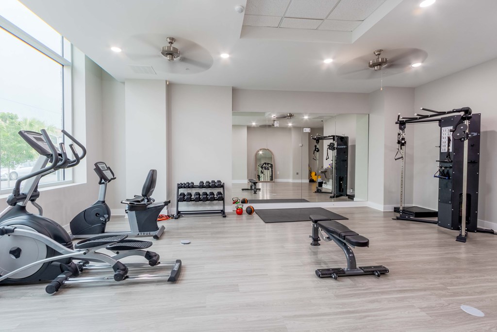 A spacious gym with a variety of equipment including treadmills, weights, and a bench press at James Lewis Jr, Charleston, SC 