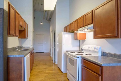 A kitchen with wooden cabinets and white appliances.